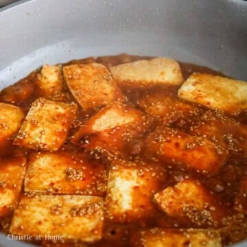 Then pour in the sauce in a circular motion to cover the tofu. Let sauce simmer to thicken, about 30 seconds. Then gently toss the tofu in the sauce.