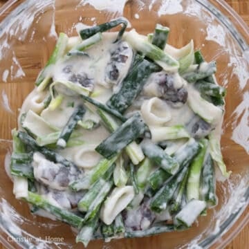 Then add green onions, shrimp, squid rings and cold water and mix just until combined.