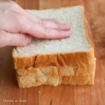 Stack the peanut buttered slices upward and adhere the plain slice on top.