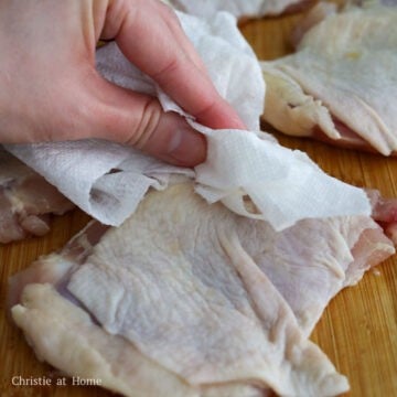Pat the chicken thighs dry on both sides with paper towels to remove any excess moisture.