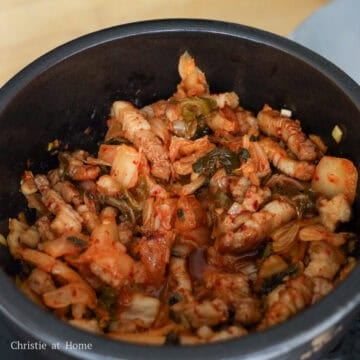Next add regular soy sauce, fish sauce, sesame oil, sugar, and gochugaru. Mix together and cook until onions become translucent, a couple minutes. Then add kimchi and cook until kimchi juices release, about 1-2 minutes.