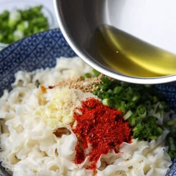 Heat vegetable oil in a small saucepan on medium-high heat. Once it smokes, remove from heat and pour the hot oil over the green onions, garlic and gochugaru.