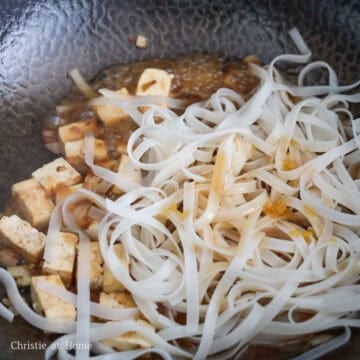 Toss in rice noodles and sauce mixing for 2-3 minutes. Taste your noodles to see if they're chewy at this point, if not add a 2-3 tablespoons of water to help cook them until they are.