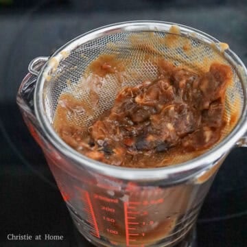 Strain as much as the tamarind liquid through a fine sieve and discard the hard bits and seeds, reserving the liquid which is now your tamarind concentrate.