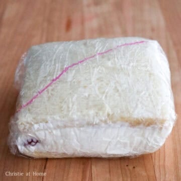 Wrap the sandwich tightly in plastic wrap. Mark a diagonal line on the wrap to indicate the direction of the strawberries. Chill in the back of the fridge for at least 30 minutes to set, or I recommend freezing it for 15-30 minutes to make slicing easier.