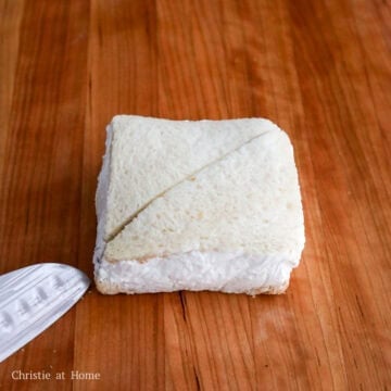 Unwrap and slice along the marked diagonal using a sharp or serrated knife. Serve immediately.