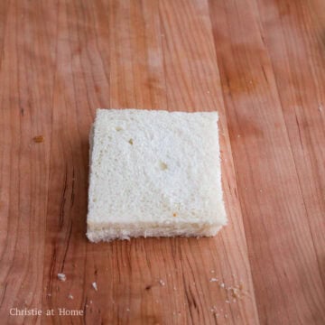 Trim the crusts from the bread using a sharp or serrated knife.