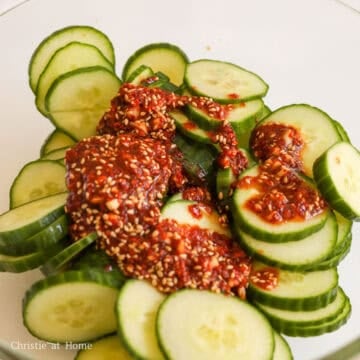 Pour dressing over cucumber pieces in the large bowl.
