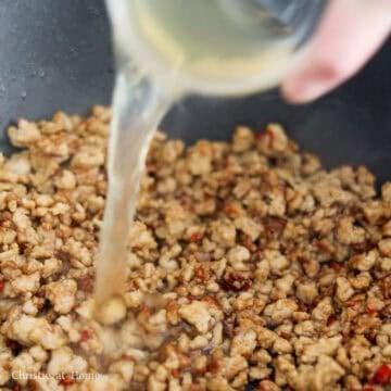 Add sauce and stir fry and then add stock and stir-fry again.