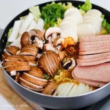 Then place the pan over your stovetop or portable gas burner and boil over medium-high heat. Let the ingredients simmer in the stock for 10-15 minutes until the mushrooms soften, stirring occasionally. Feel free to cover with a lid if needed to speed up the process.