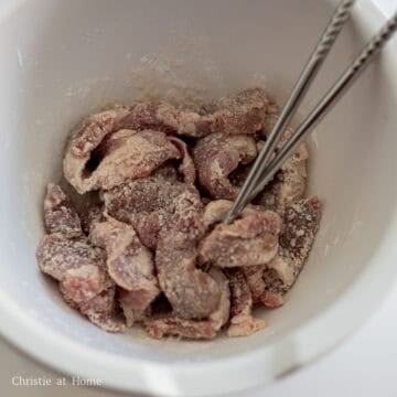 In a large bowl, add pork strips, cornstarch, salt and Shaoxing wine. Mix well until pork strips are well coated in cornstarch. Set aside.