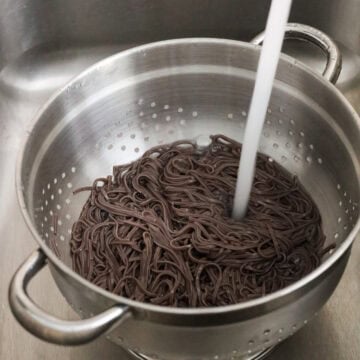 Strain noodles and rinse noodles off with cold running water until they are cool to touch. Strain out as much excess water as possible. Transfer strained noodles to a large bowl.