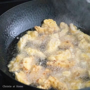 Heat vegetable oil in a large pan on medium heat. Once the oil temperature reaches 350 degrees F with a digital instant read thermometer or place a chopstick in the oil and when you see bubbles form, fry battered pork in small batches. Fry for 5-6 minutes flipping it over until golden brown. Remove and transfer to a wire rack or a paper towel lined plate to remove excess oil.