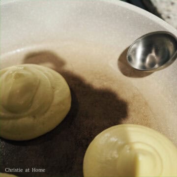 Spoon 1 teaspoon of water in empty surrounding spaces of the pan avoiding the pancakes.