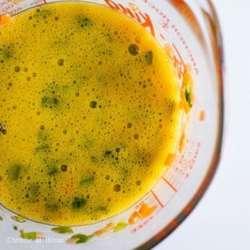 In a large measuring cup with a lip or a large bowl, beat eggs and add finely chopped ham, carrots, garlic chives and salt. Mix well.