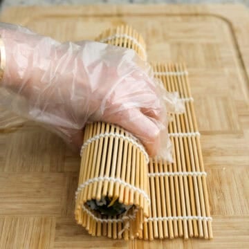 Firmly roll the kimbap away from you tightly tucking in the ingredients. Then hold the roll until it’s set and doesn’t fall apart, about 10 seconds. Let the kimbap rest for a few minutes. Repeat this for the remaining three kimbap rolls.