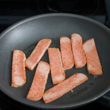 Slice spam into ¼ inch-thick rectangular shape pieces. Then slice each piece into half so you have two 1-inch wide strips equal in size. Fry the spam on medium heat without oil until golden brown on both sides, about 2 minutes per side. Remove and set aside.