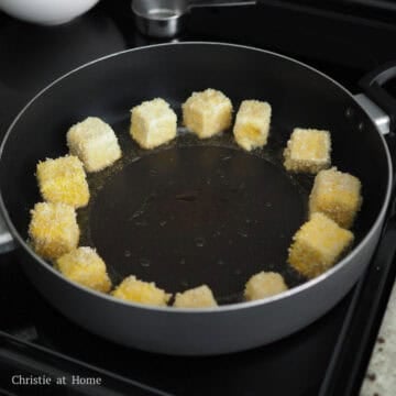 Next heat vegetable oil in a large pan on medium heat, around 350 degrees F with a digital instant read thermometer or place a wooden utensil into the oil and if bubbles form, it's time to fry. Fry tofu on each side until golden brown, about 2-3 minutes per side. Transfer the fried tofu to a wire rack or paper-towel lined plate to remove excess oil.