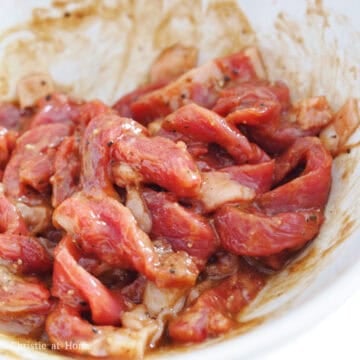 Transfer sliced flank steak into a large bowl and marinate with the marinade ingredients as listed above for 15-20 minutes.