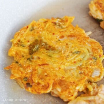 Flip pancakes over with a spatula. Pour another 2 tablespoon of vegetable oil around the pancakes. Fry on the other side until golden crispy brown. Remove pancakes from pan and transfer to a wire rack or paper-towel lined plate to remove excess oil. Serve with your favourite condiment and enjoy!