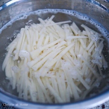 In a large bowl, soak potato slices in cold water for a couple of minutes and strain out the water using a colander. Shake out as much excess water as possible and dry the potatoes with a clean paper towels.