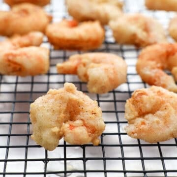 Remove and drain the fried shrimp on a wire rack or paper towel lined plate to remove excess oil.