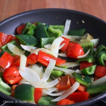 Heat the vegetable oil in a large pan over medium heat. Add the onions and garlic, and stir-fry for about 30 seconds, until fragrant. Add the bell peppers and cook for 30–60 seconds, until slightly softened.