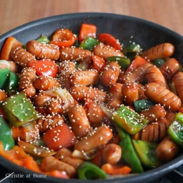 Add the sausages and stir-fry for 1 minute. Cover and cook for 3 minutes, or until the sausages are cooked through. Add the sauce and toss to combine. Garnish with sesame seeds, remove from heat, and enjoy!