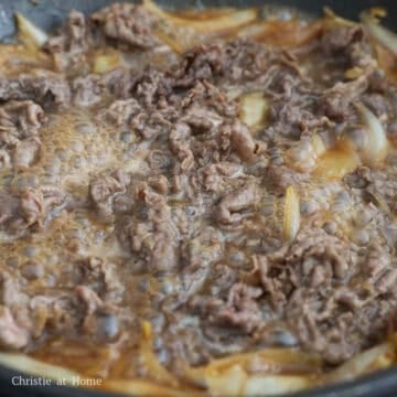 Mix in the sliced beef with the onions and cook it through, about 2-3 minutes.