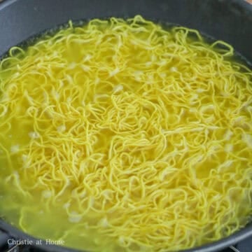 Fill a large pan or wok with enough water and bring to a boil on high heat. Blanch chow mein noodles just until loosened, about 20 seconds. Then strain the noodles in a colander and shake out excess water. Set aside.