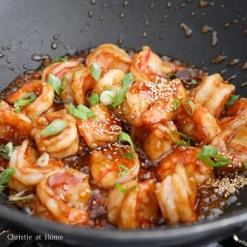 Then toss in the shrimp in the sauce until fully pink and cooked through, about 20 seconds. Remove the pan off heat. Garnish with green onions and sesame seeds. Enjoy!