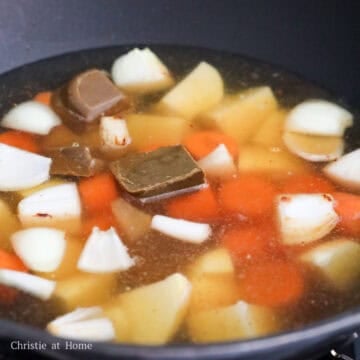 Break up curry block with your hands and add to the pan. Then add water and mix.