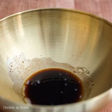 In a medium-sized mixing bowl, combine regular soy sauce, perilla oil, and sugar and mix until the sugar dissolves to create the noodle sauce. Set aside.