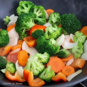 Add onions, vegetables and water and cook for 1 minute.